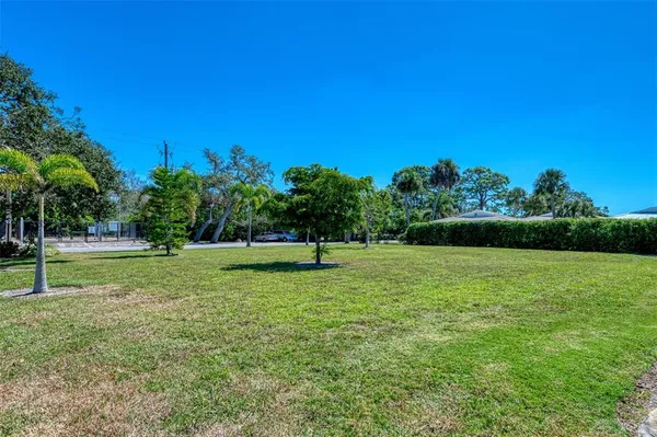a view of yard with swimming pool and green space