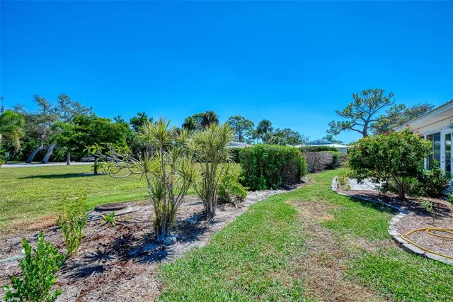 a view of yard with swimming pool and green space