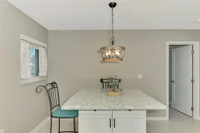 a dining room with furniture a window and a chandelier