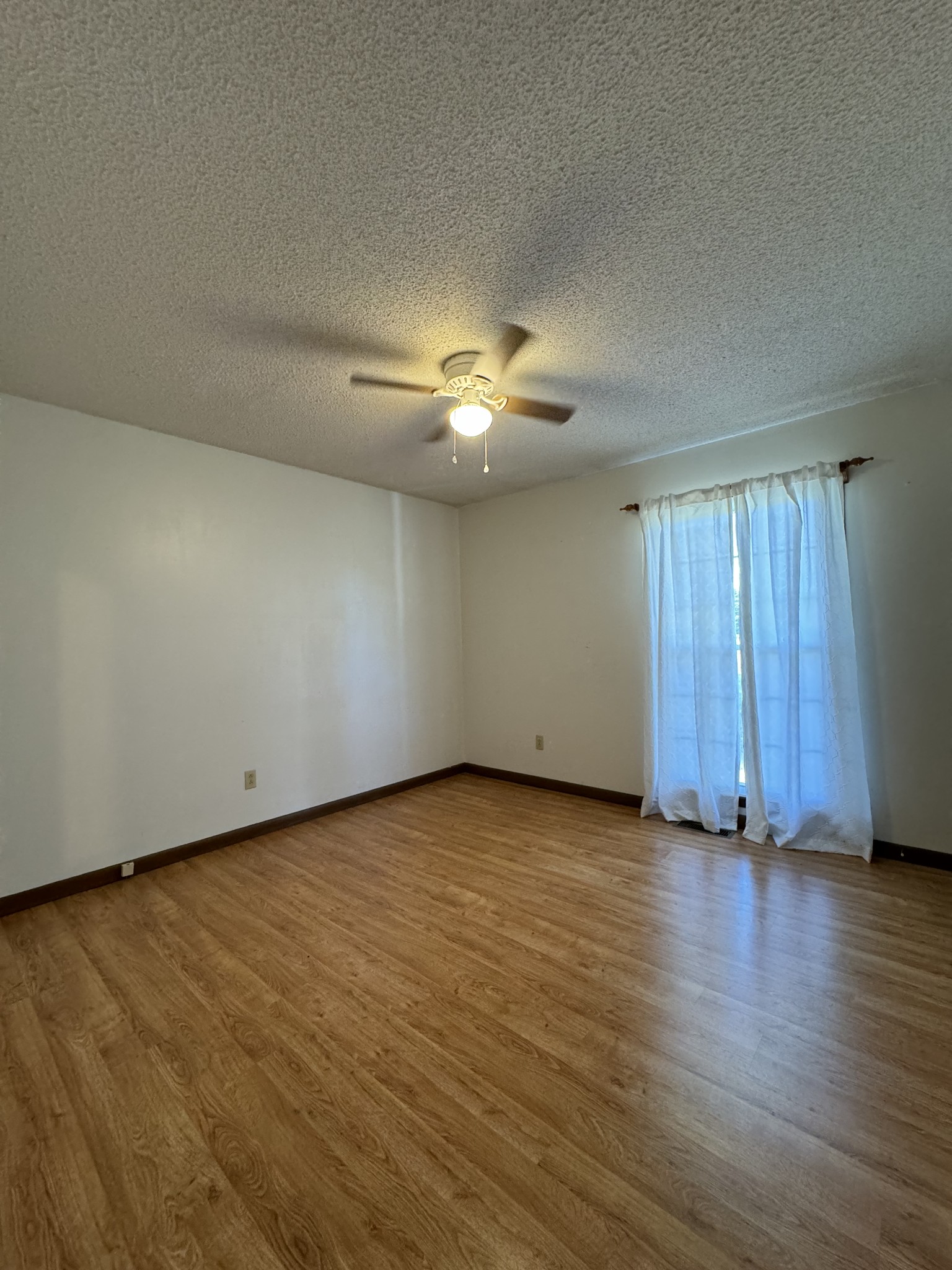 1792 Austin Road Lafayette, TN 37083 - Photo 14 of 34 an empty room with wooden floor and windows