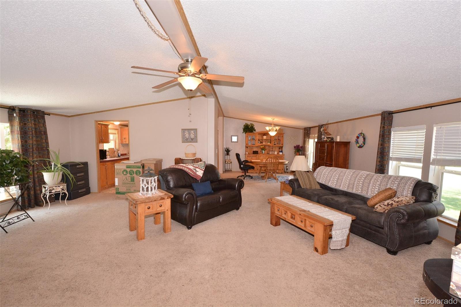 30640 Aldred Road Pueblo, CO 81006 - Photo 15 of 34 a living room with furniture and a chandelier