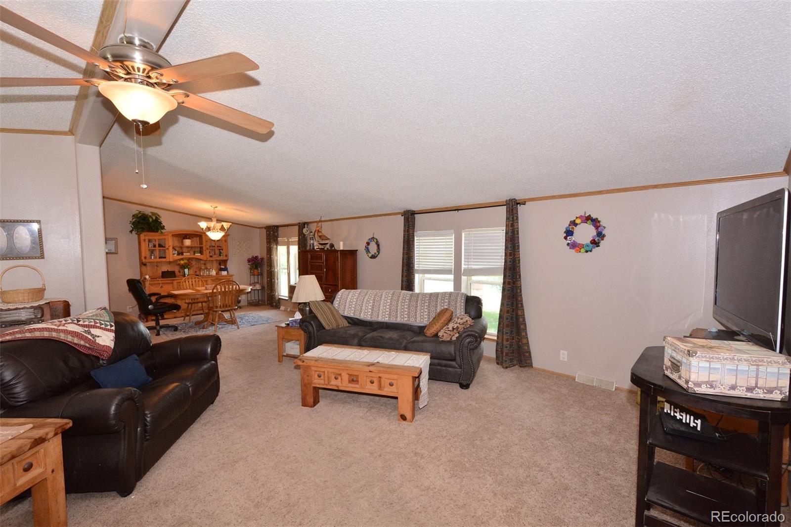 30640 Aldred Road Pueblo, CO 81006 - Photo 17 of 34 a living room with furniture and a flat screen tv