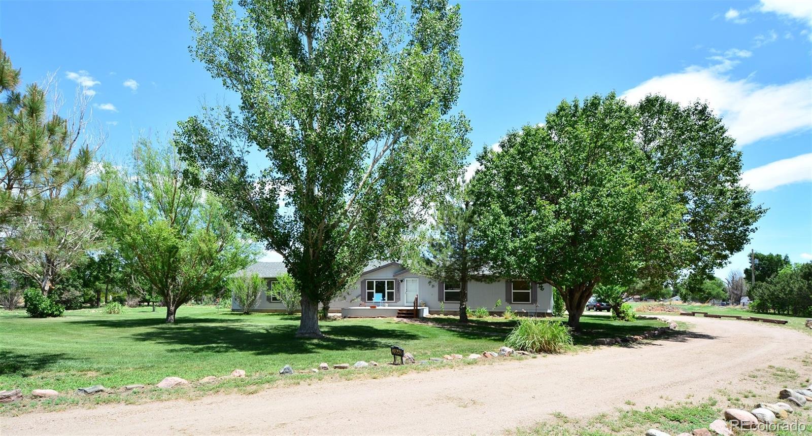 30640 Aldred Road Pueblo, CO 81006 - Photo 2 of 34 a front view of a house with a yard