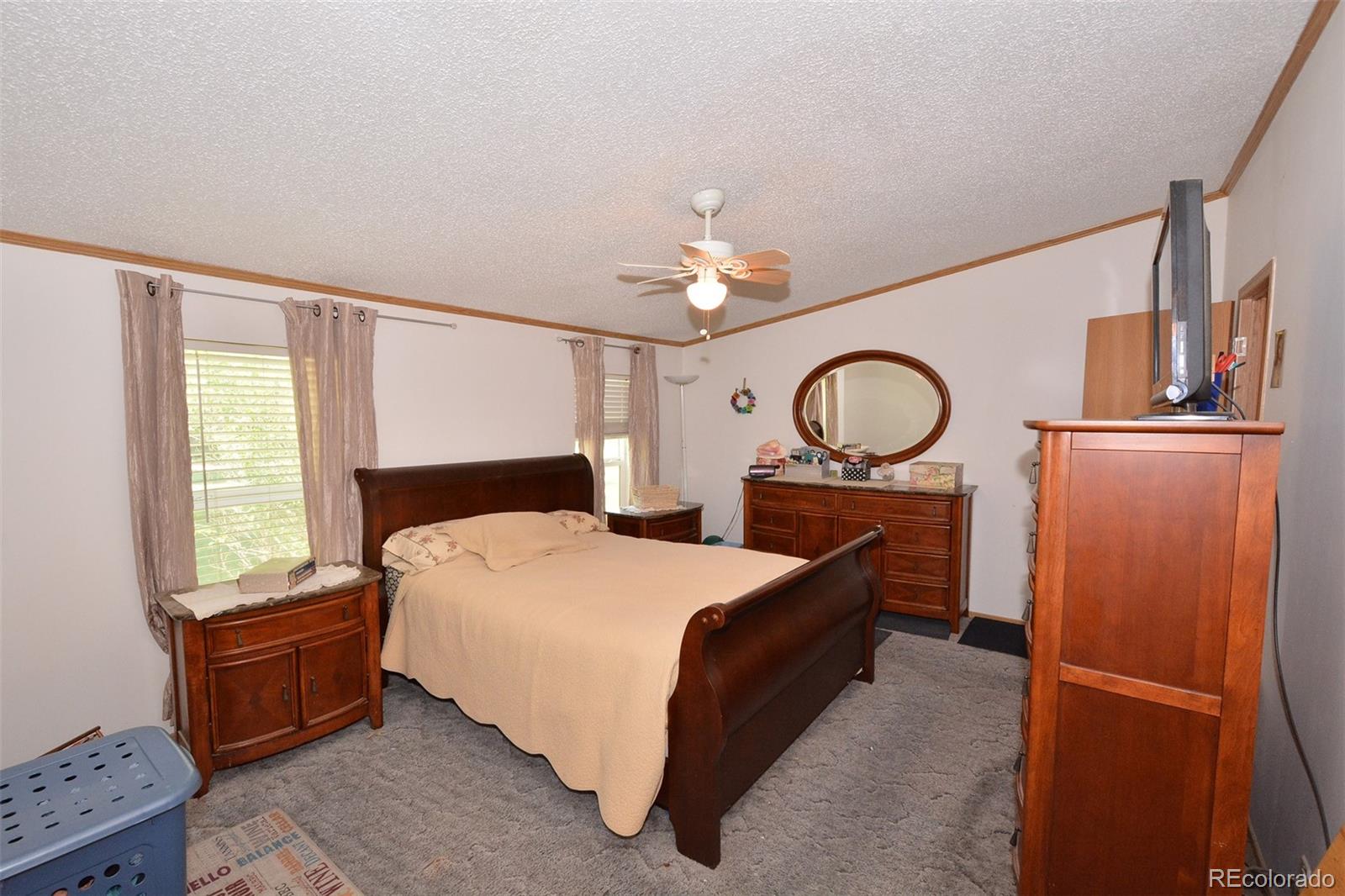 30640 Aldred Road Pueblo, CO 81006 - Photo 24 of 34 a bedroom with a bed dresser and a window