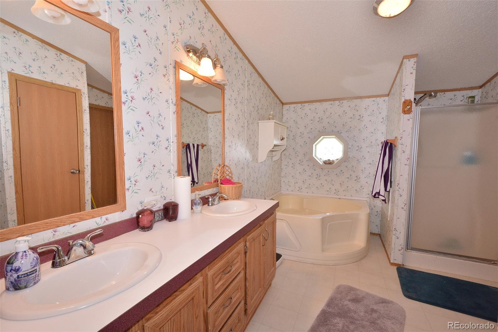 30640 Aldred Road Pueblo, CO 81006 - Photo 26 of 34 a spacious bathroom with a double vanity sink mirror double and shower