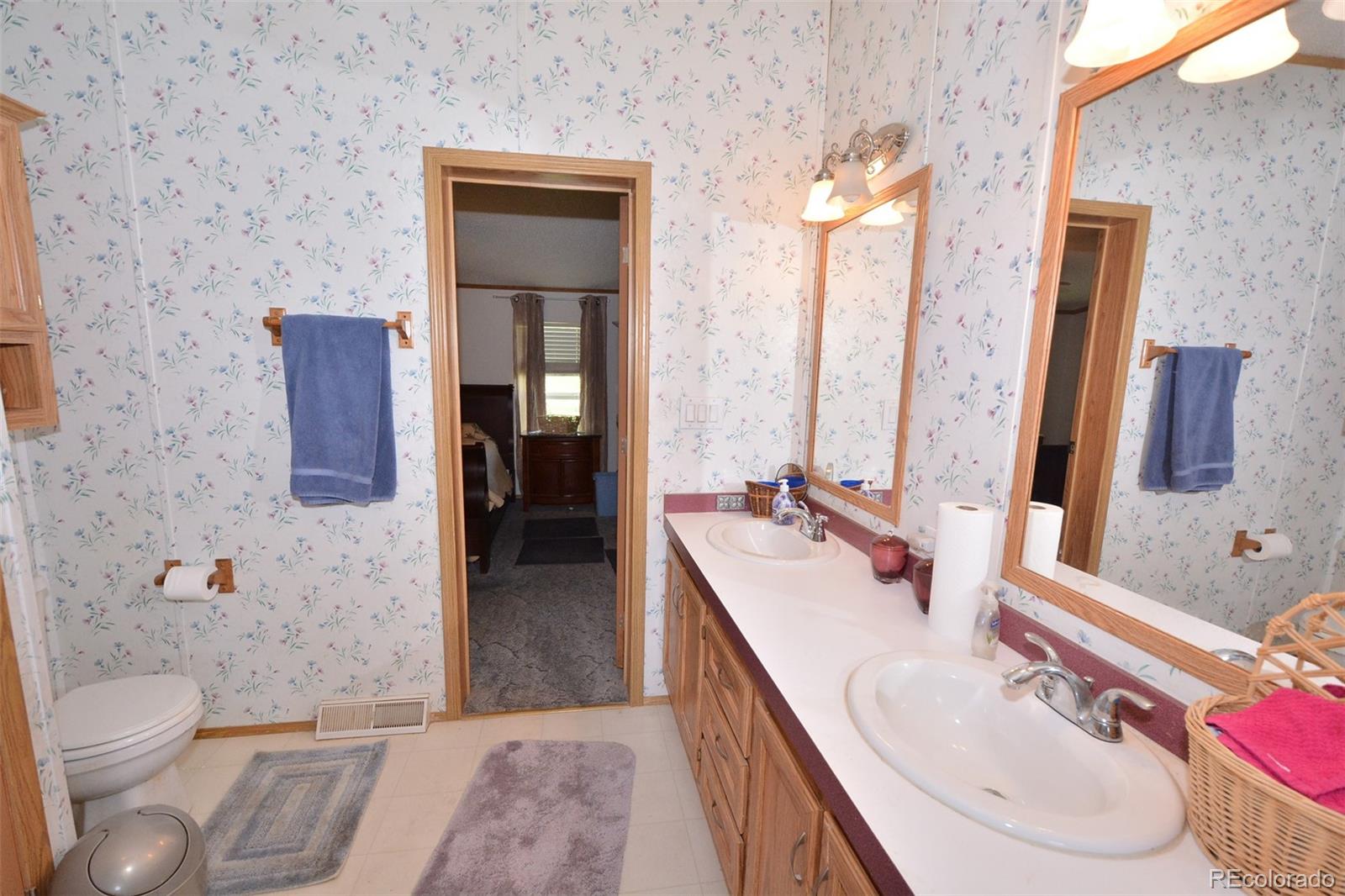 30640 Aldred Road Pueblo, CO 81006 - Photo 27 of 34 a bathroom with a double vanity sink toilet and shower