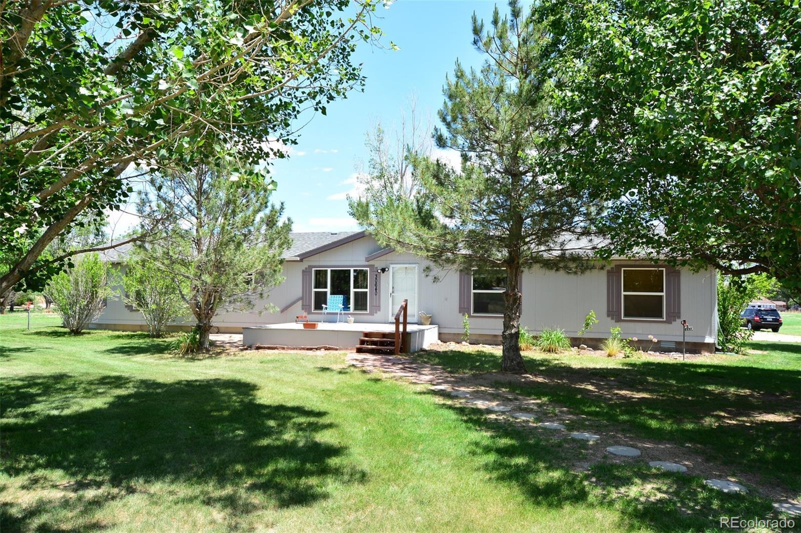 30640 Aldred Road Pueblo, CO 81006 - Photo 3 of 34 a front view of house with yard and trees