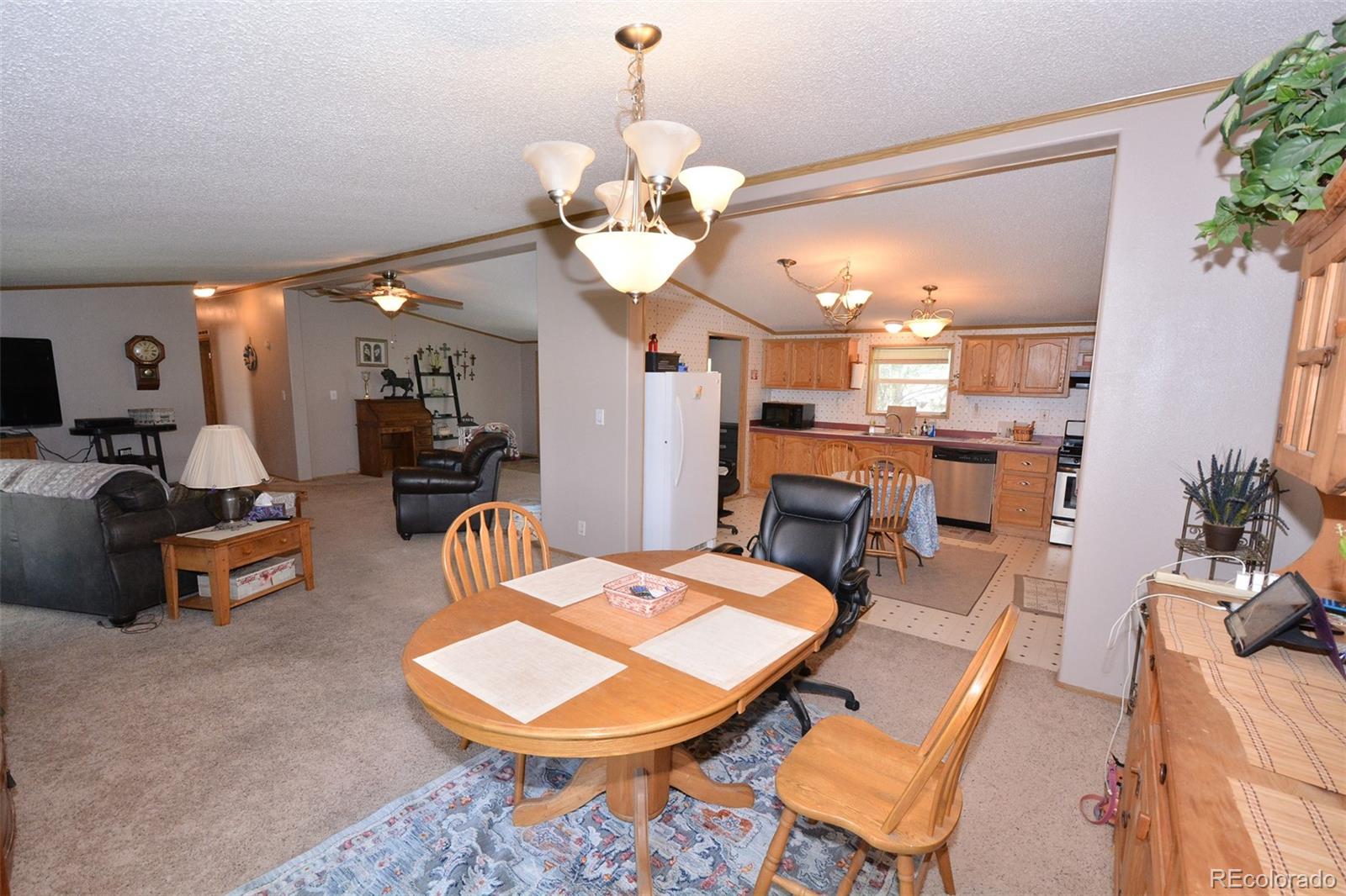 30640 Aldred Road Pueblo, CO 81006 - Photo 33 of 34 a very nice looking dining room with a table and chairs