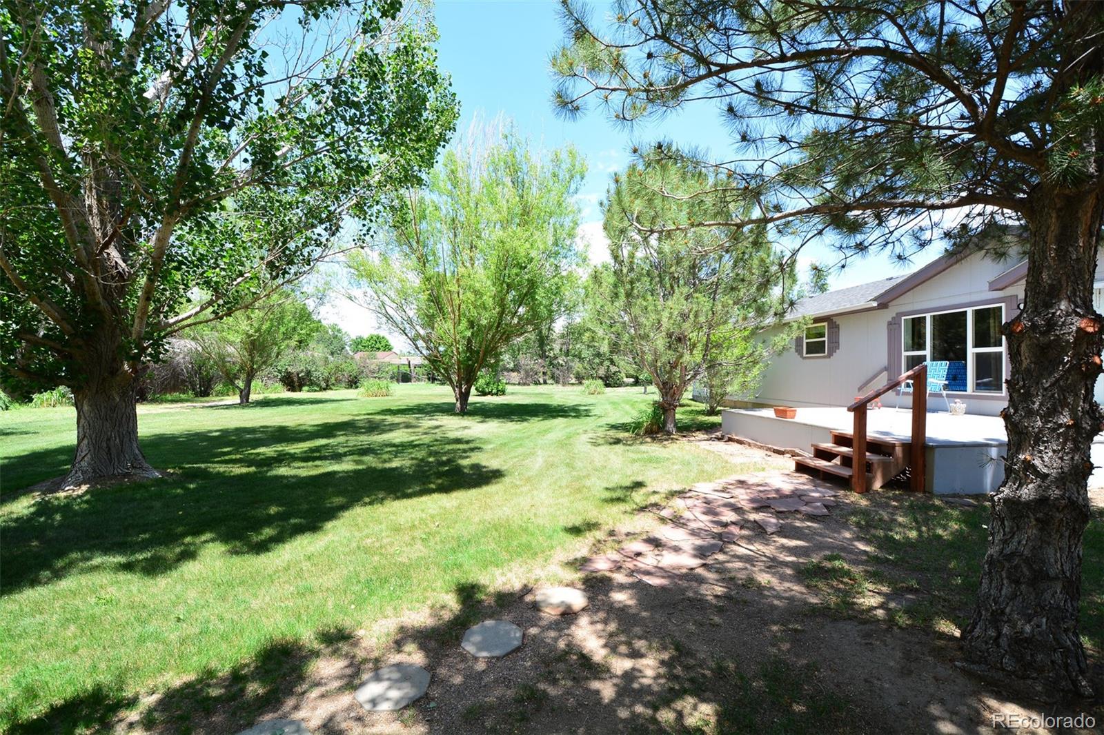 30640 Aldred Road Pueblo, CO 81006 - Photo 4 of 34 a backyard of a house with yard and outdoor seating