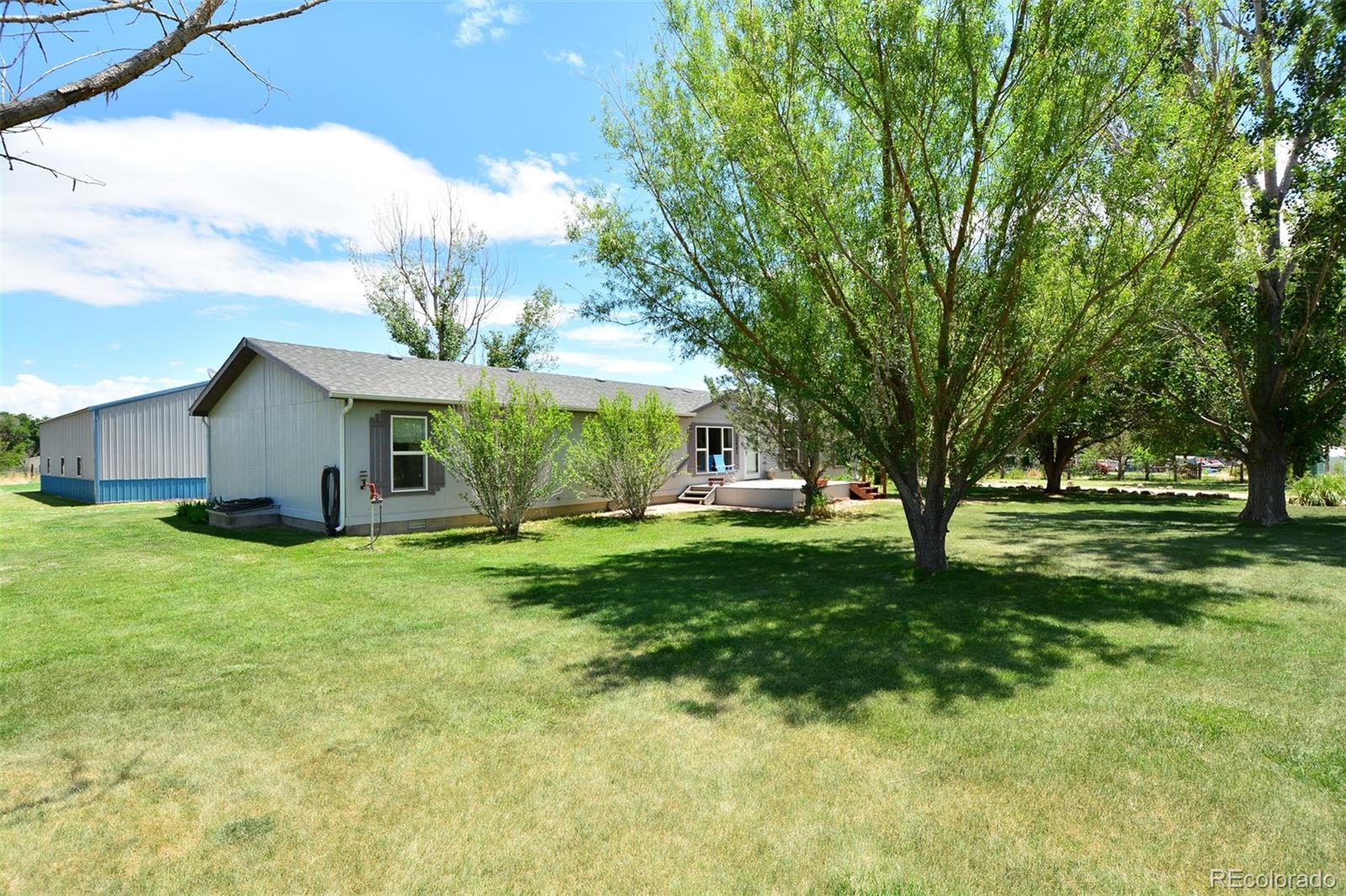 30640 Aldred Road Pueblo, CO 81006 - Photo 5 of 34 a view of a house with a backyard