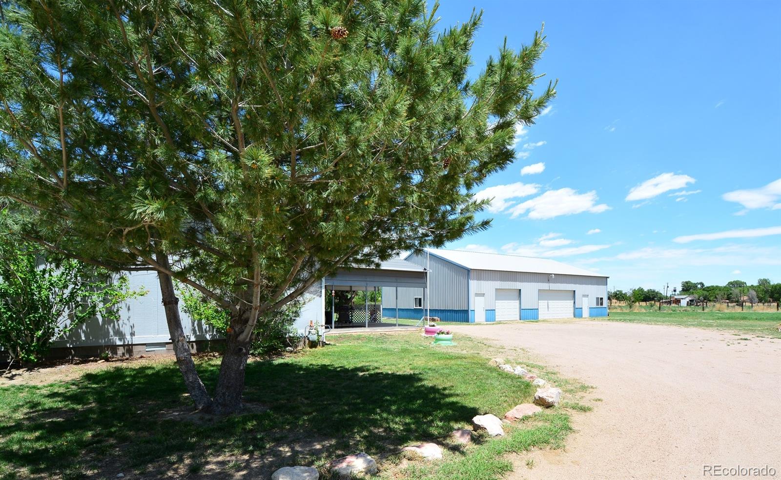 30640 Aldred Road Pueblo, CO 81006 - Photo 6 of 34 a front view of a house with a garden
