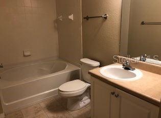 5550 East Michigan Street, Unit 3232 Orlando, FL 32822 - Photo 14 of 21 a bathroom with a sink toilet and shower