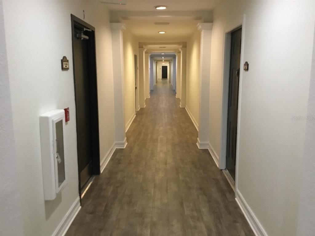 5550 East Michigan Street, Unit 3232 Orlando, FL 32822 - Photo 6 of 21 a view of a hallway with wooden floor
