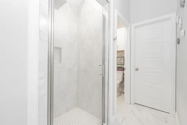 a bathroom with a glass shower door