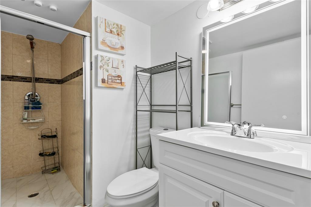 9300 Southwest 8th Street, Unit 102 Boca Raton, FL 33428 - Photo 14 of 23 a bathroom with a sink toilet and shower