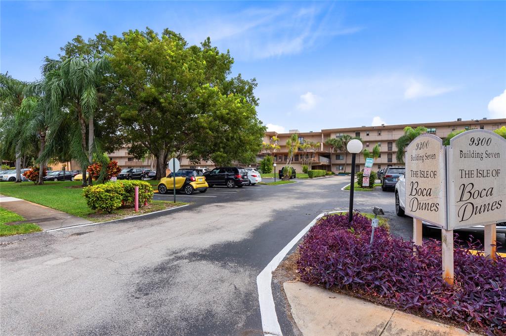 9300 Southwest 8th Street, Unit 102 Boca Raton, FL 33428 - Photo 19 of 23 a view of a street with cars parked