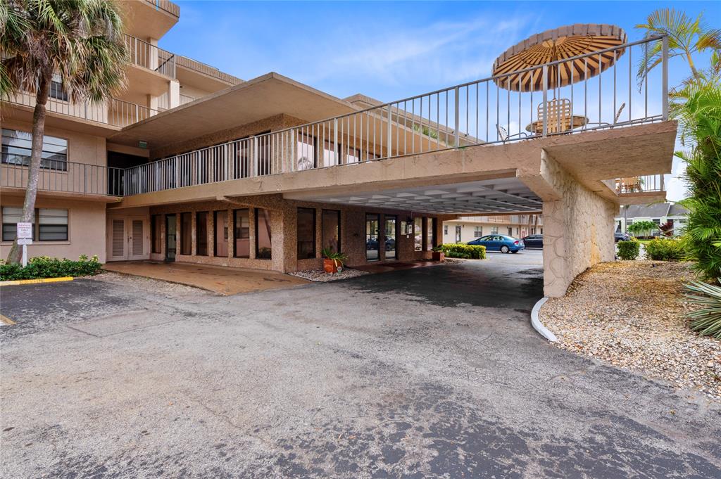9300 Southwest 8th Street, Unit 102 Boca Raton, FL 33428 - Photo 20 of 23 a view of a house with a yard and sitting area