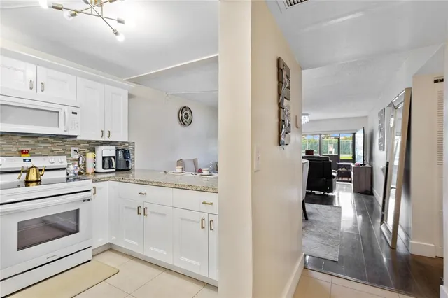a kitchen with cabinets and wooden floor