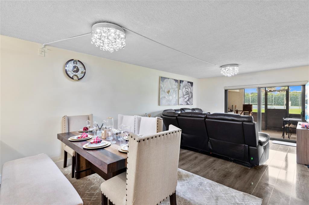 9300 Southwest 8th Street, Unit 102 Boca Raton, FL 33428 - Photo 8 of 23 a living room with furniture and a table