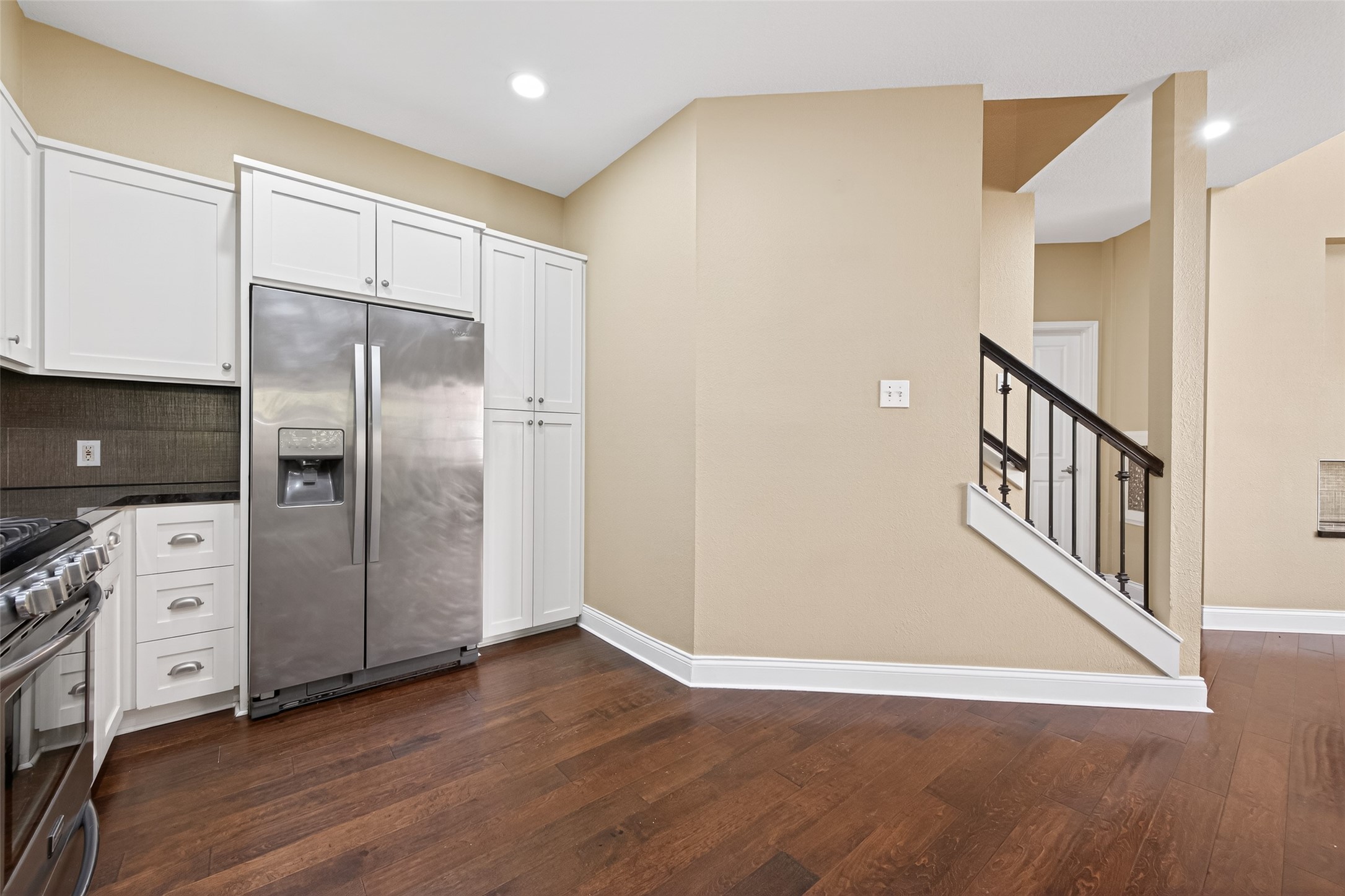 65 Scarlet Woods Court Spring, TX 77380 - Photo 10 of 36 a kitchen with stainless steel appliances a refrigerator and wooden floor