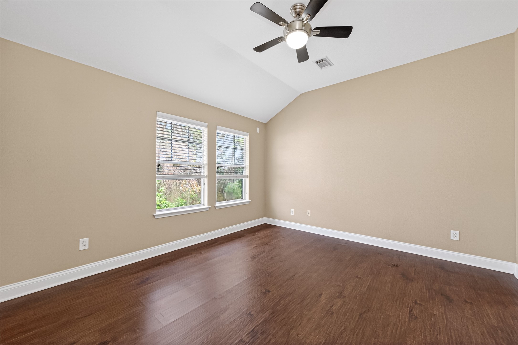 65 Scarlet Woods Court Spring, TX 77380 - Photo 21 of 36 an empty room with wooden floor fan and windows