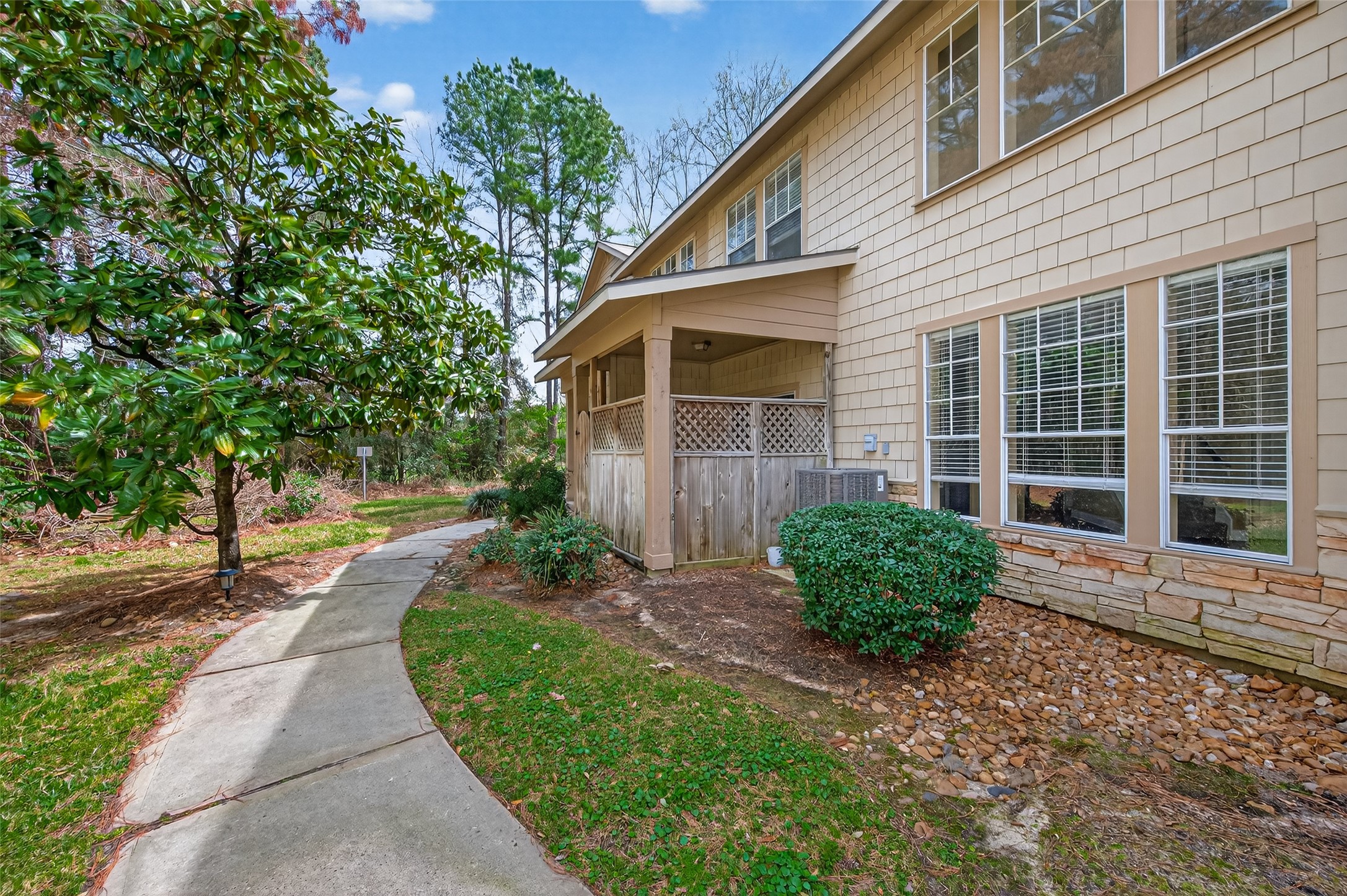 65 Scarlet Woods Court Spring, TX 77380 - Photo 32 of 36 a front view of a house with a yard and potted plants