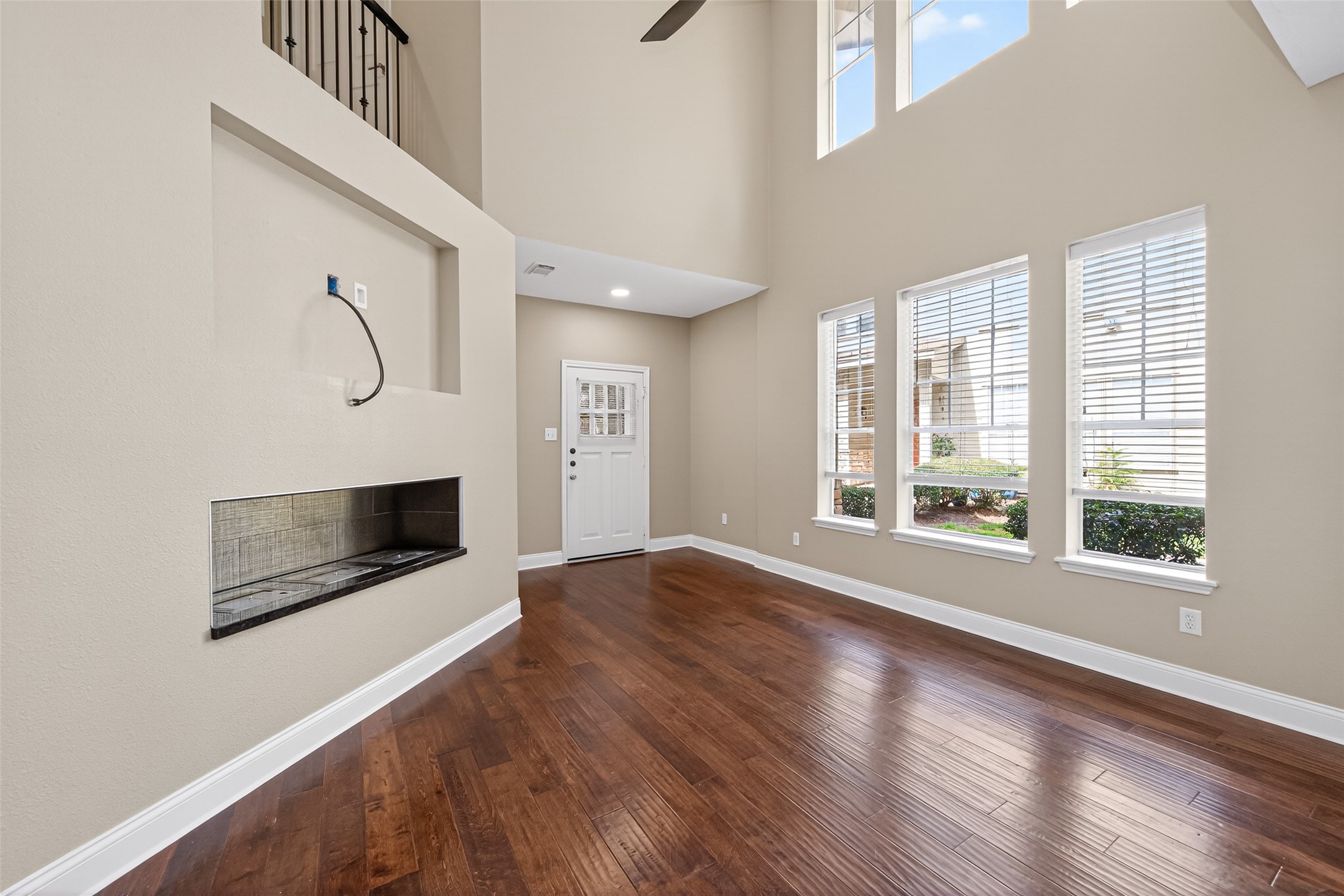 65 Scarlet Woods Court Spring, TX 77380 - Photo 4 of 36 a view of an empty room with wooden floor and a window