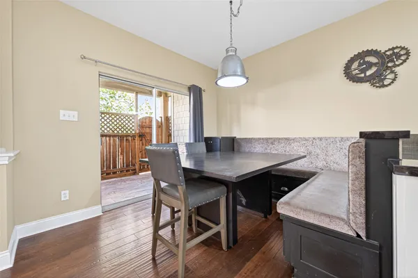 a kitchen with stainless steel appliances kitchen island granite countertop a table chairs a sink and a refrigerator