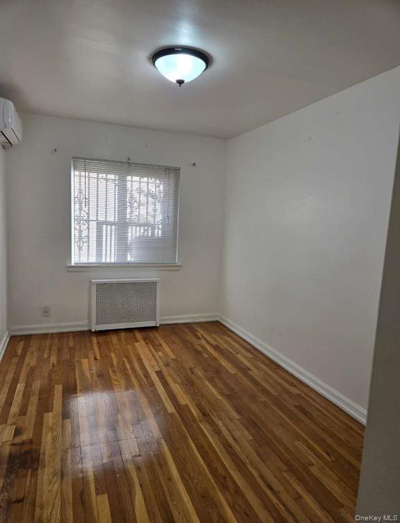 132-20 60th Avenue Queens, NY 11355 - Photo 6 of 8 an empty room with wooden floor and windows