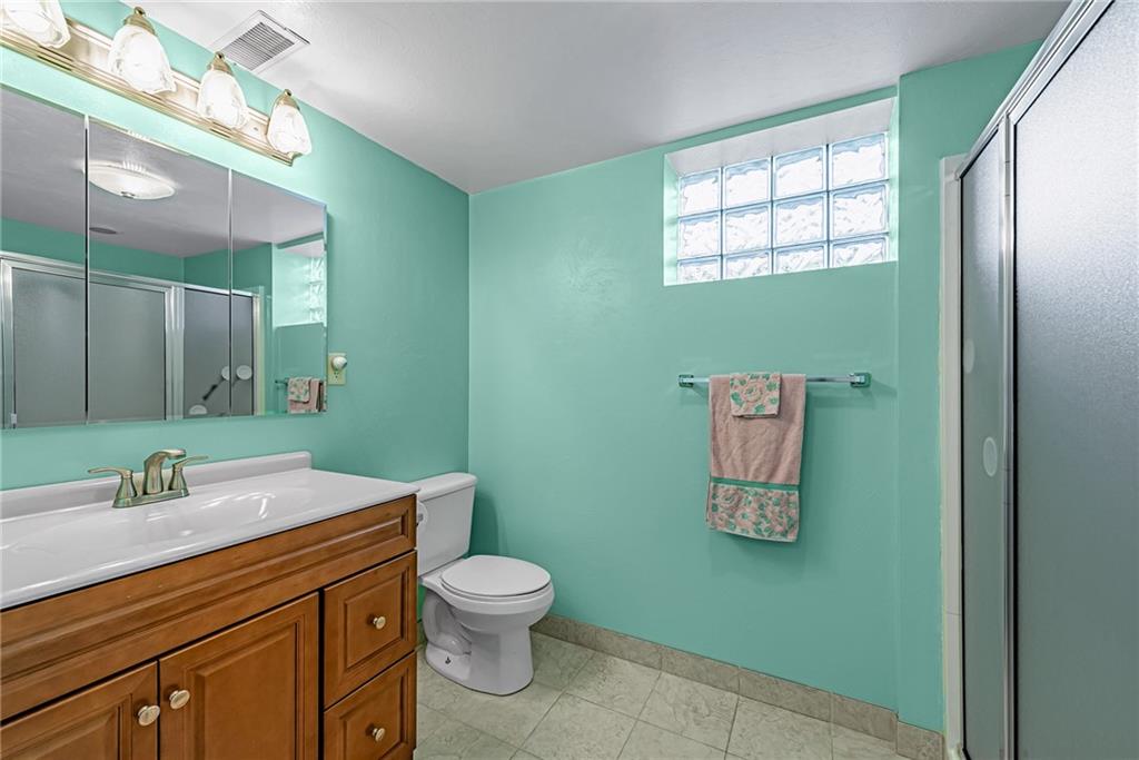 4931 North Rt, Unit 982 Latrobe, PA 15650 - Photo 17 of 22 a bathroom with a toilet sink and mirror