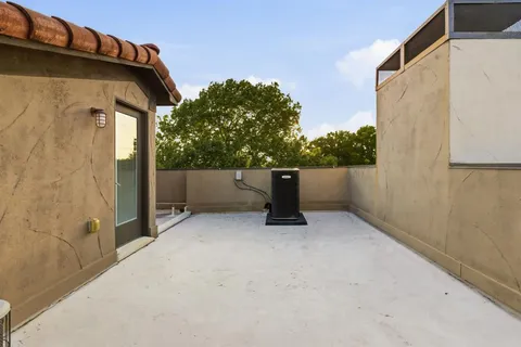 a backyard of a house with chairs and a fire pit