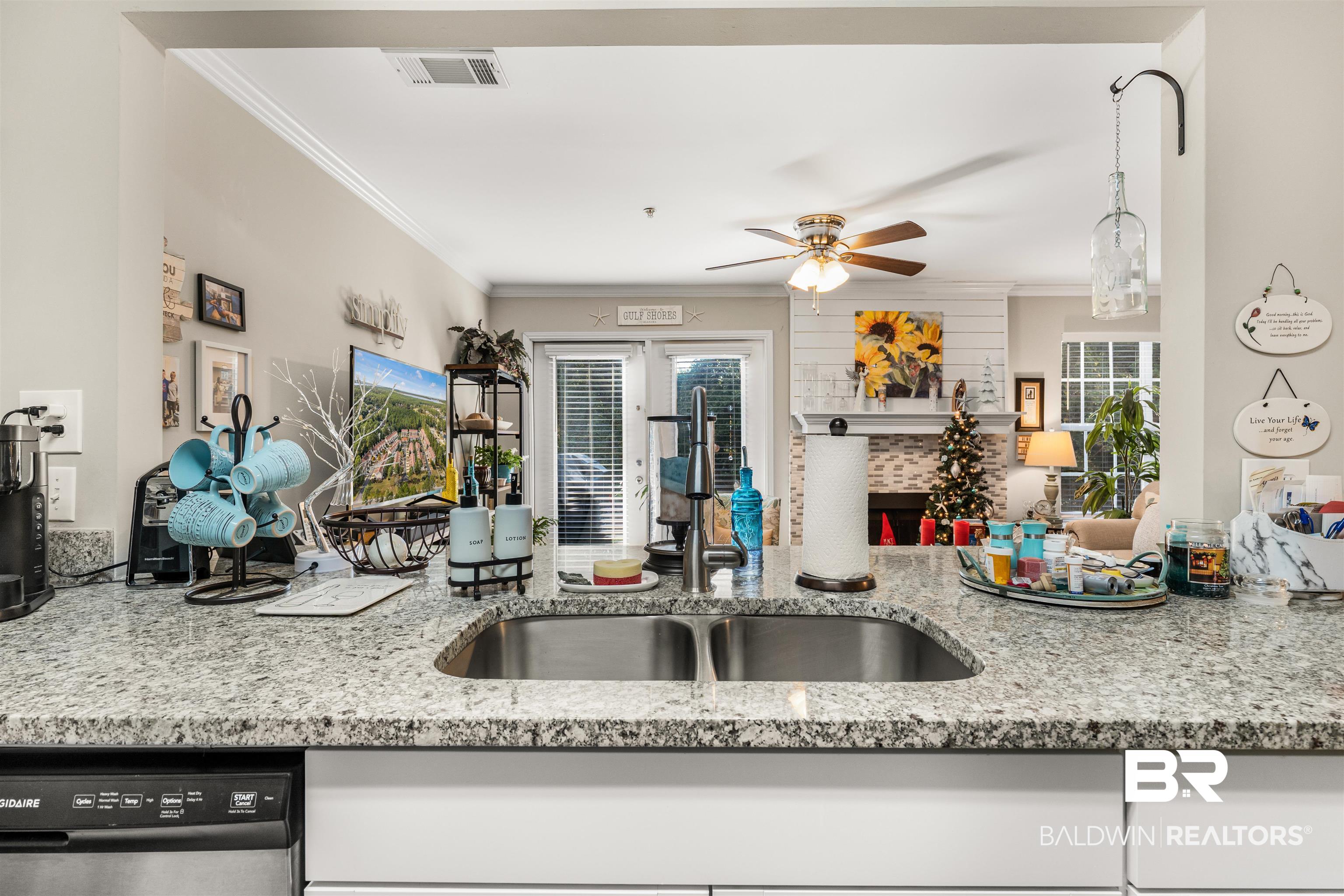 1517 Regency Road, Unit 68 Gulf Shores, AL 36542 - Photo 16 of 43 Kitchen with stainless steel dishwasher, ceiling fan, sink, and crown molding