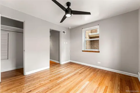 a view of empty room with wooden floor