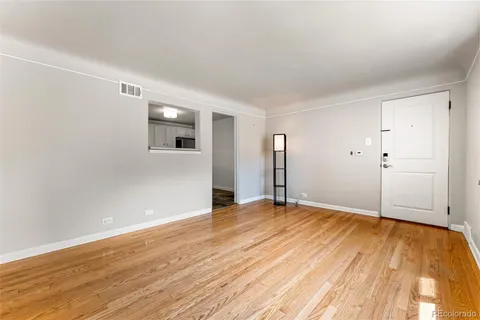 a view of an empty room with wooden floor