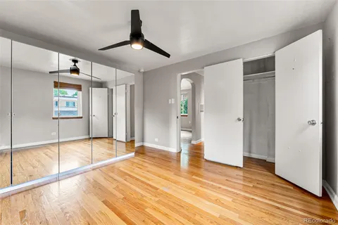 a view of empty room with wooden floor