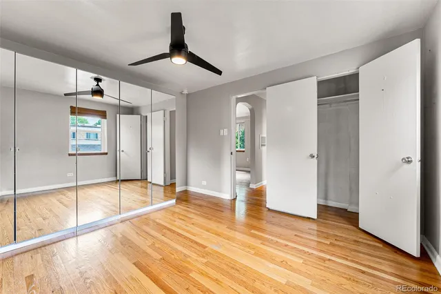 a view of empty room with wooden floor