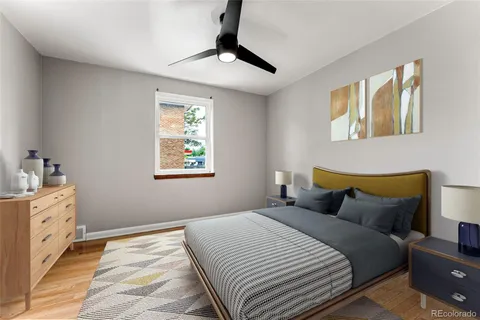 a bedroom with a bed and a lamp on the dresser