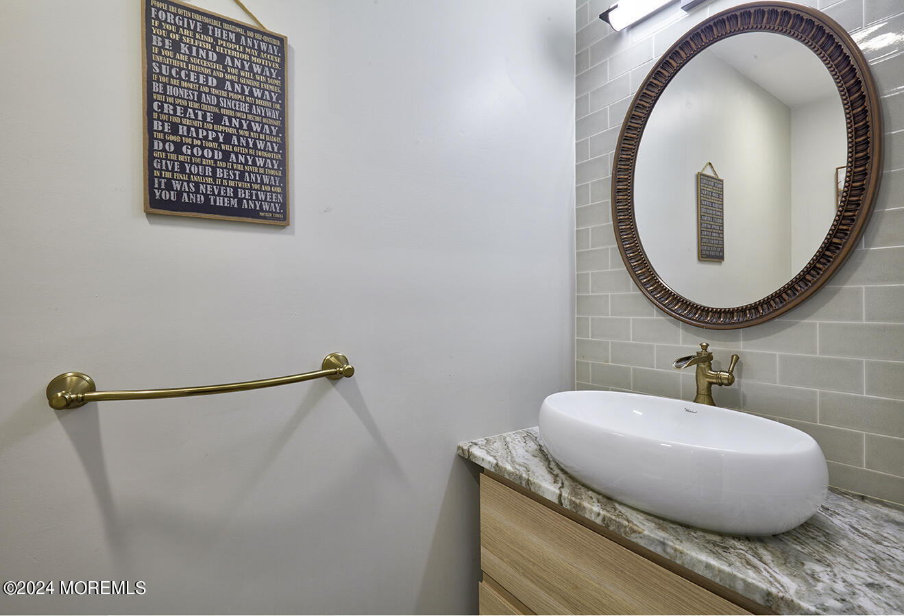 321 Spring Street, Unit 1 Red Bank, NJ 07701 - Photo 8 of 20 a bathroom with a granite countertop sink and a mirror