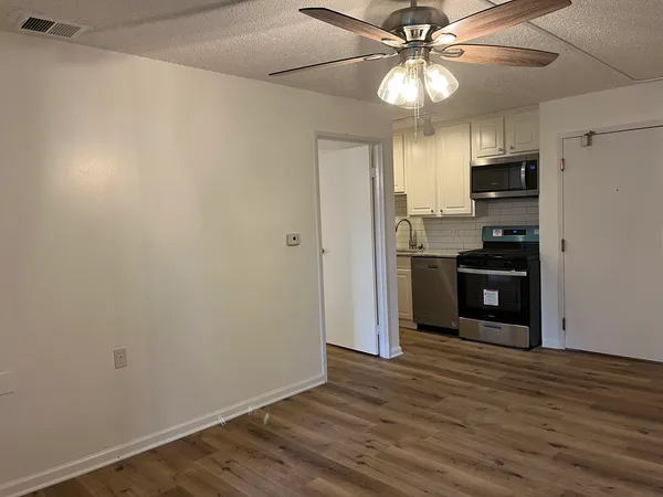 a kitchen with stainless steel appliances a refrigerator and a stove top oven