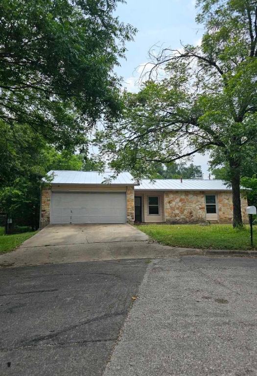 a front view of a house with a yard and a garage