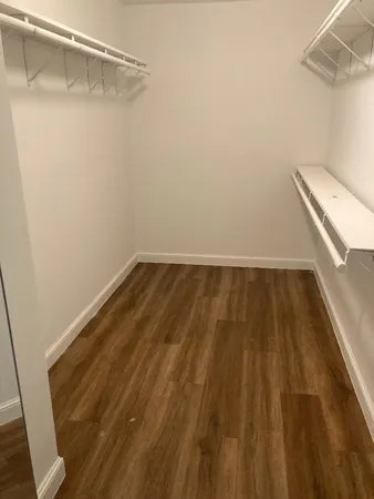 a view of a room with wooden floor