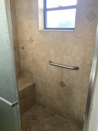 a bathroom with a glass shower door