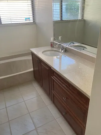 a bathroom with a sink a vanity and a mirror
