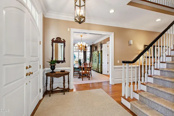 a view of a dining room with furniture and chandelier
