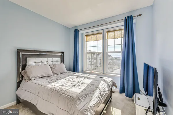 a bedroom with a large bed and a large window