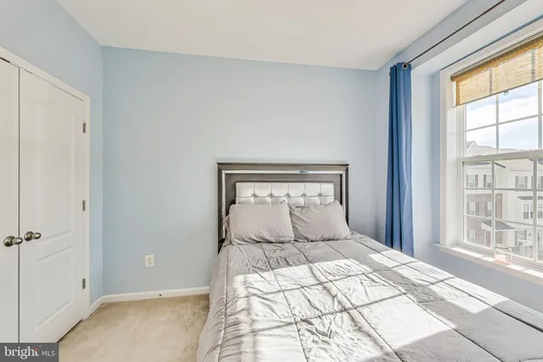 a bedroom with a large bed and a window