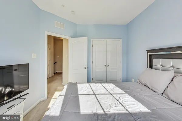 a bedroom with a bed and a television