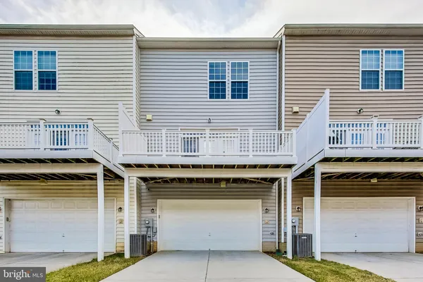 a view of a house with barbeque and wooden fence
