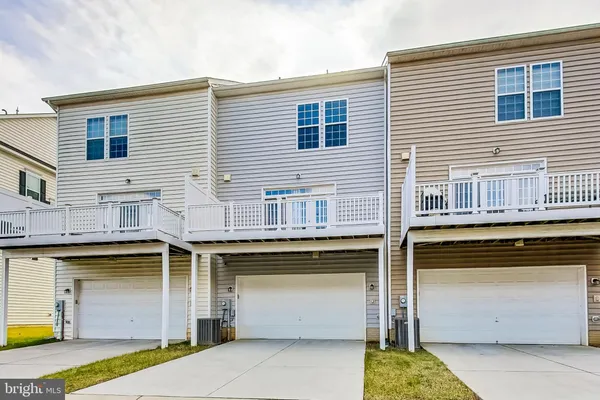 a view of a house with a barbeque and large door