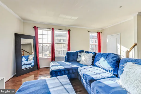 a living room with furniture and a floor to ceiling window